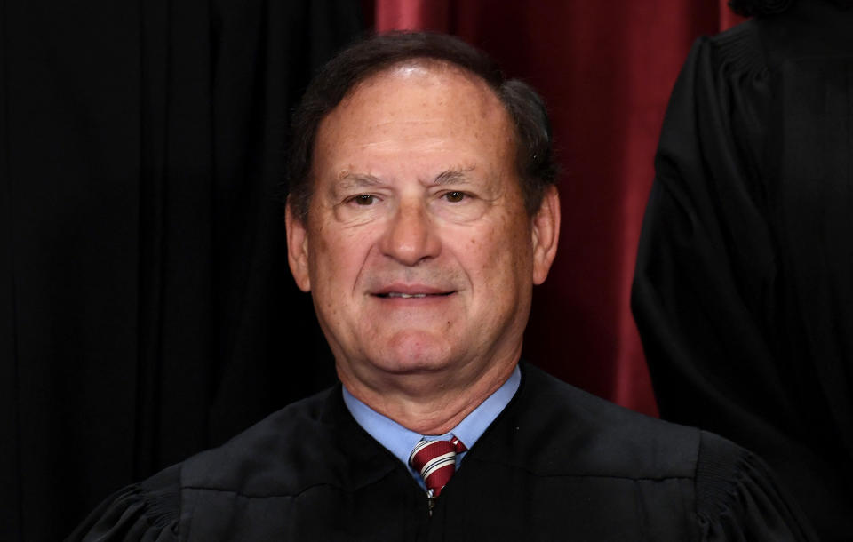 Justice Samuel Alito poses, looking self-satisfied.