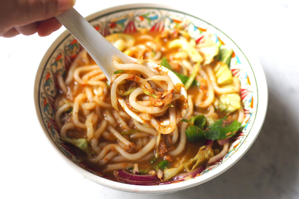 Slurp up the mildly spicy broth with bits of fish together with the rice noodles.