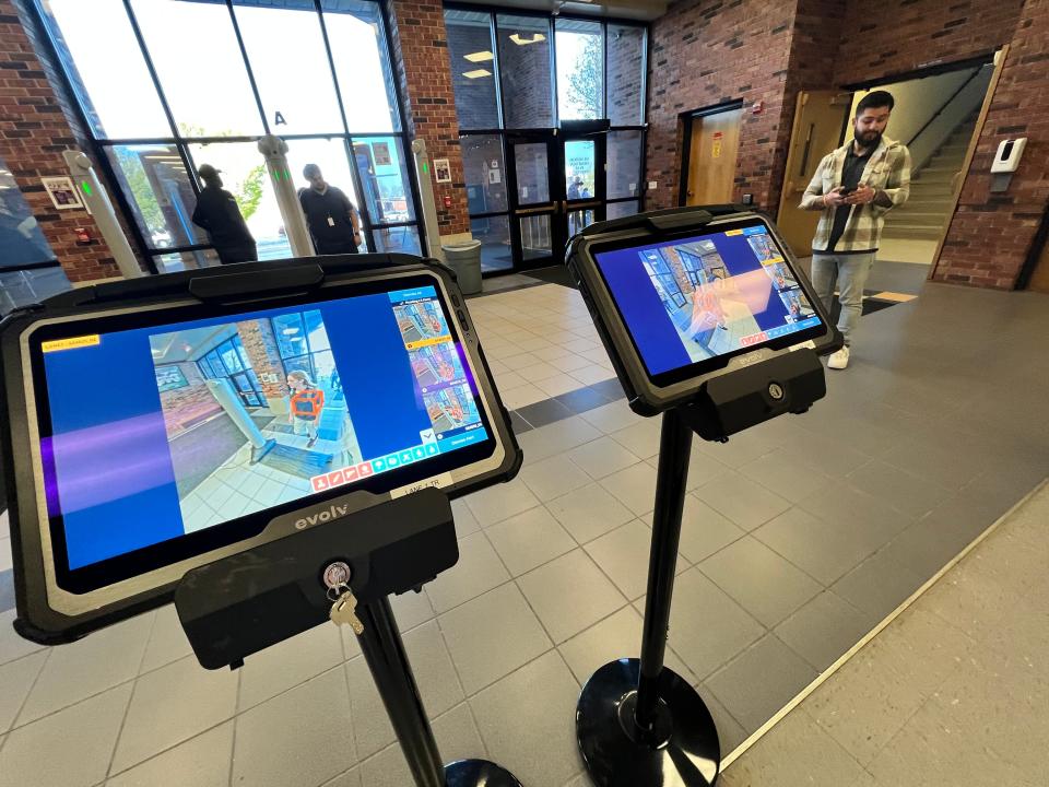 Screens show people passing through an entrance to Hickman High School during a demonstration of Evolv Technology this week.