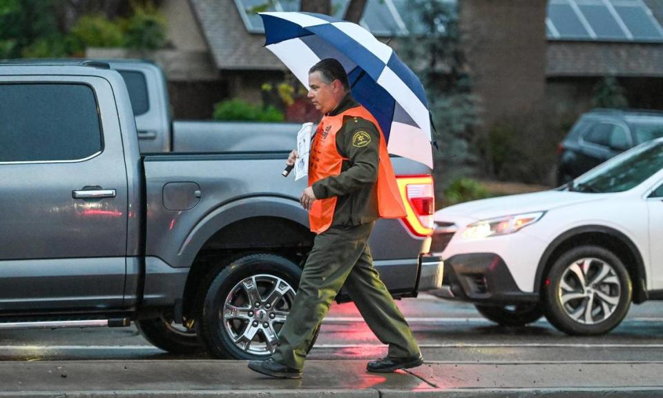 Fresno County Sheriff John Zanoni sells Kids Day newspapers at the corner of Friant and Audubon in Fresno on Tuesday, March 12, 2024.