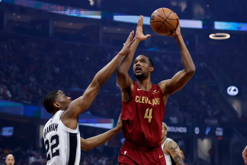 Cleveland Cavaliers forward Evan Mobley (4) shoots against San Antonio Spurs guard Malaki Branham (22) during the first half of an NBA basketball game, Monday, Feb. 13, 2023, in Cleveland. (AP Photo/Ron Schwane)