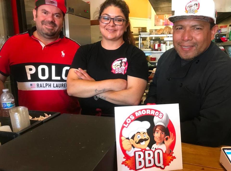 Los Morros BBQ owner-partners Miguel Fuentes, left, and Arturo Guatemala, right, flank employee Paulina Salcedo as they prepare for a long-awaited grand opening of the new eatery Monday, Aug. 14, 2023.
