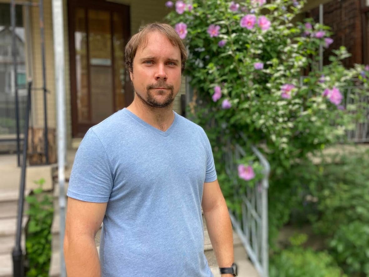 Airbnb superhost Brandon Wall stands in front of his home near Little Italy. He says he's frustrated with Airbnb since it hasn't helped hosts or guests after it cancelled all his future bookings this year. (Keith Burgess/CBC - image credit)