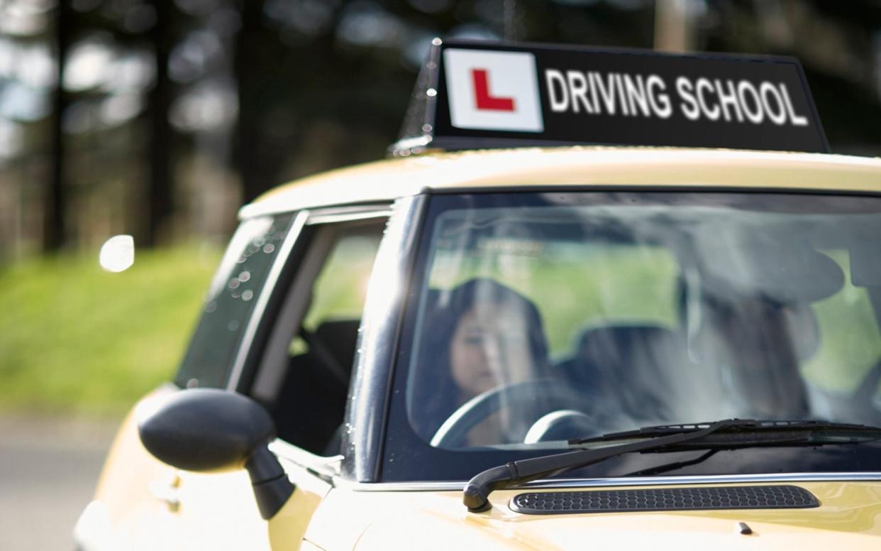  Female learner driver behind wheel of car -  Dark Horse