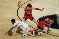 Southern California's Tahj Eaddy, left, and Utah's Alfonso Plummer, right, fall in front of Mikael Jantunen (20) during the first half of an NCAA college basketball game in the quarterfinal round of the Pac-12 men's tournament Thursday, March 11, 2021, in Las Vegas. (AP Photo/John Locher)