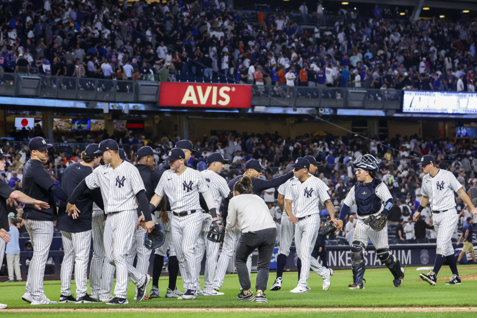 The New York Yankees celebrate their win after a baseball game against the New York Mets, Monday, Aug. 22, 2022, in New York. (AP Photo/Corey Sipkin)