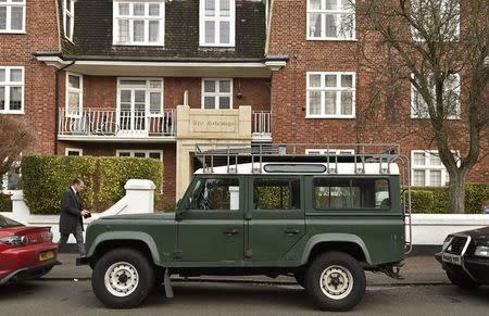 A man walks past a Land Rover Defender parked on a street in London, Britain, January 29, 2016. REUTERS/Toby Melville