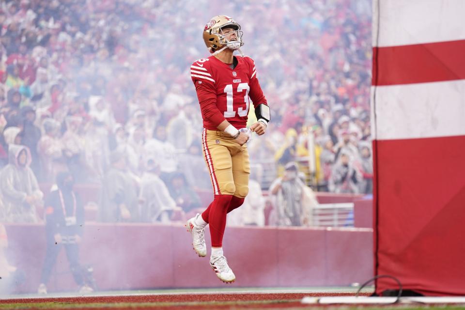 San Francisco 49ers quarterback Brock Purdy runs onto the field before a wild card game against the Seattle Seahawks.