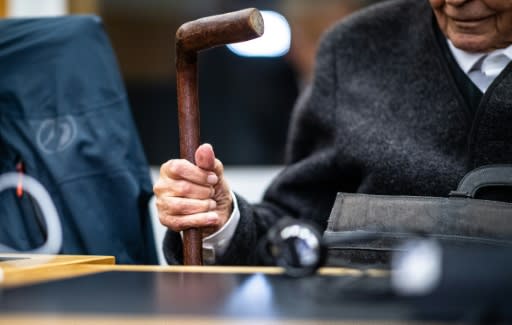 A 93-year-old former SS guard holds his walking stick during his trial at the regional court in Muenster, Germany