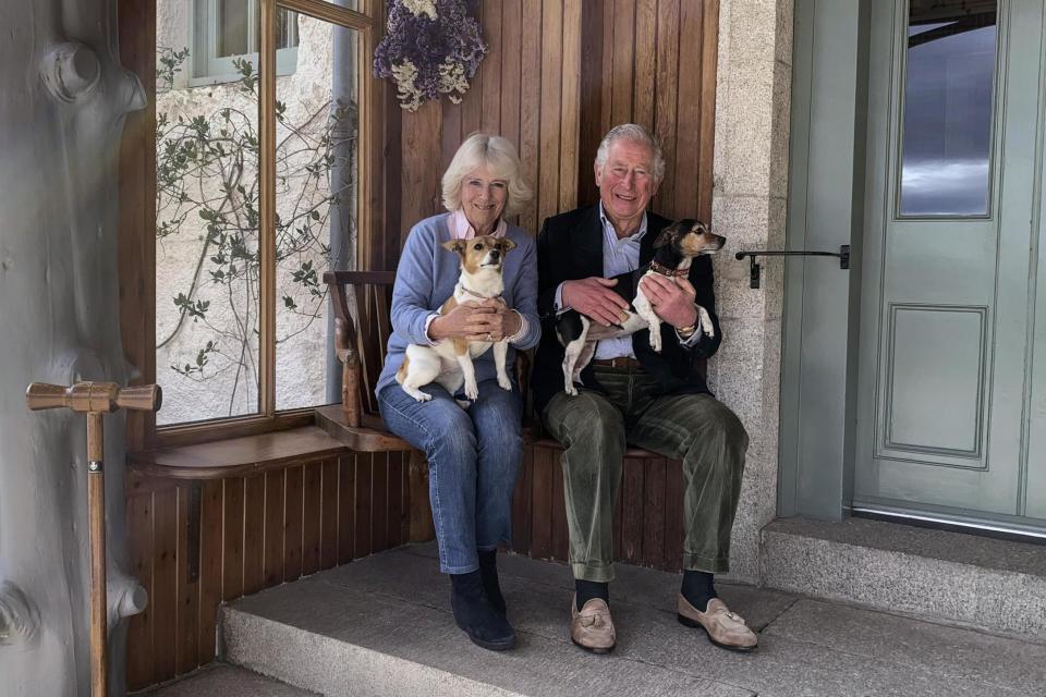 Charles and Camilla pose for a photo with their dogs Beth and Bluebell (AP)