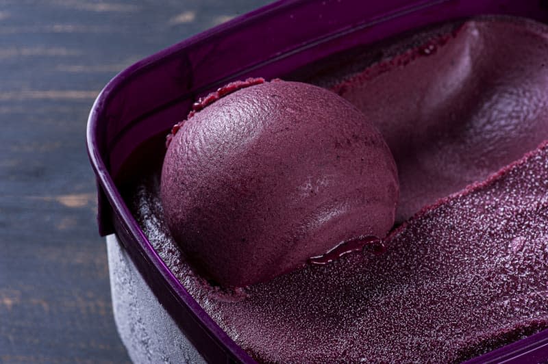 Close-up of frozen Brazilian açaí in a purple box. Fruit of Amazon (Acai). Top view