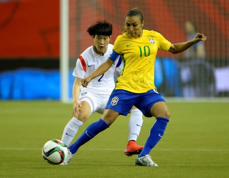 Jun 9, 2015; Montreal, Quebec, CAN; Brazil midfielder Marta (10) controls the ball in front of Korea Republic defender Lee Eunmi (2) in the second half a Group E soccer match in the 2015 FIFA women's World Cup at Olympic Stadium. Mandatory Credit: Eric Bolte-USA TODAY Sports