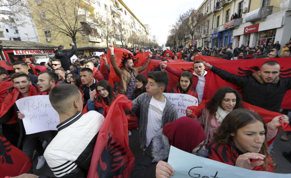 University and school students wave Albanian flags as they protest in Tirana, Tuesday, Dec. 11, 2018. Student demands include cutting tuition fees in half, doubling the budget for education and a greater student presence on decision-making boards. (AP Photo/ Hektor Pustina)