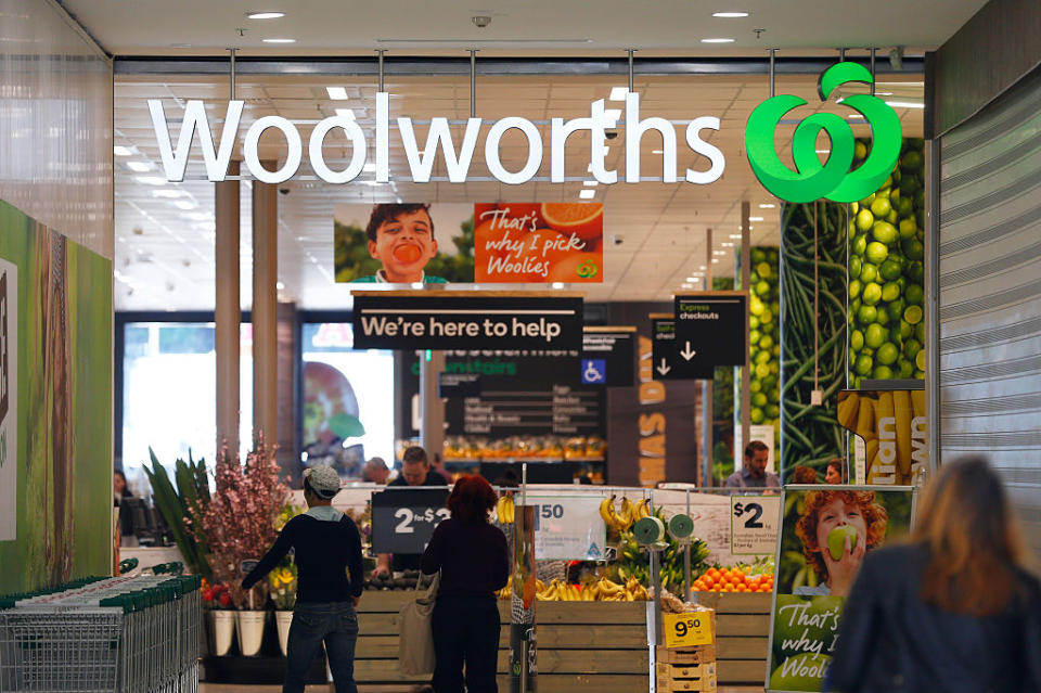 Customers stand outside a Woolworths store.