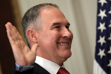 FILE PHOTO: Director of Environmental Protection Agency Scott Pruitt is sworn in by Justice Samuel Alito (not pictured) at the Executive Office in Washington February 17, 2017. REUTERS/Carlos Barria/File Photo