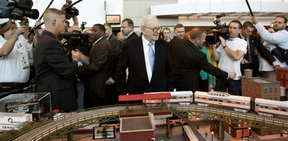 Berkshire Hathaway Chairman and CEO Warren Buffett, center, surveys a model railroad featuring BNSF trains, prior to participating in the annual shareholders meeting, in Omaha, Neb. (AP Photo/Nati Harnik, File)