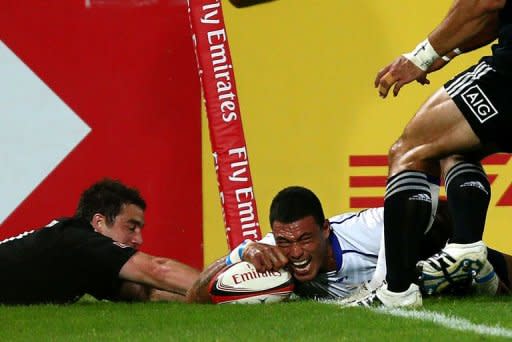 Samoa's Lio Lolo (R) scores a try despite New Zeland's Kurt Baker during their International Rugby Board Sevens World Series rugby union final match in Dubai. Samoa won 26-15