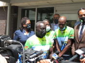 Marcus Arbery Sr., green and white shirt and black mask, speaks with reporters Tuesday, May 11, 2021, following a court hearing for three men charged with federal hate crimes in the slaying of his son, Ahmaud Arbery, outside the federal courthouse in Brunswick, Ga. Justice Department prosecutors say Ahmaud Arbery was targeted because he was Black when he was chased and fatally shot by white men who saw Arbery running in their neighborhood on Feb. 23, 2020. All three defendants pleaded not guilty to hate crime charges before a U.S. magistrate judge. They are also charged with murder in a Georgia state court. (AP Photo/Russ Bynum)