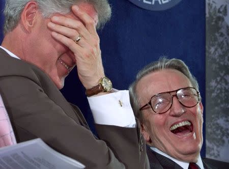 U.S. President Bill Clinton (L) laughs during a ceremony to dedicate a vaccine research center to former Senator Dale Bumpers (R) and his wife, Betty, at the National Institute of Health in Bethesda, Maryland, in this file photo taken June 9, 1999. REUTERS/Larry Downing/Files