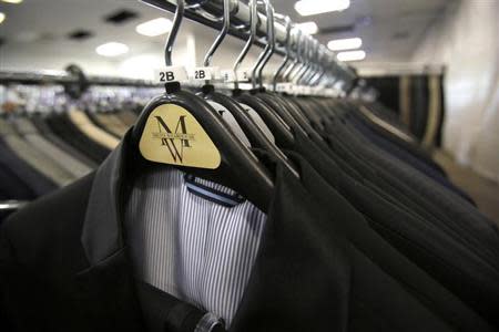 Suits hang on a rack at a Men's Wearhouse store in Pasadena, California June 25, 2013. REUTERS/Mario Anzuoni