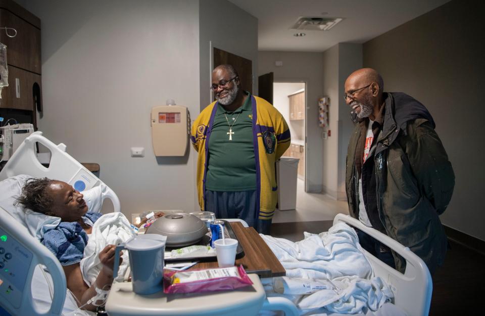 The Revs. Vincent Johnson and George Armstrong pray over Mary Bradley while on bedrest at the TriStar Skyline Medical Center in Nashville, Tenn. Bradley was injured when an EF-2 rated tornado with 130 mph winds hit Community Baptist Church and flattened the structure. 35 parishioners were inside, including Bradley, and some had to be dug out of the rubble.