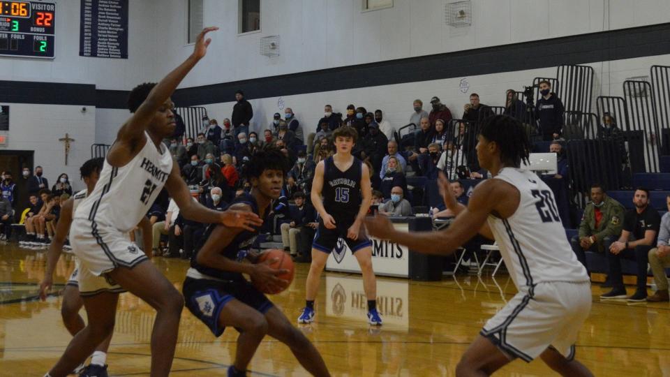 Wildwood Catholic's Azmir Kates (24) prepares to shoot as Ife Okebiorun (21) and Elijah Brown of St. Augustine defend during third-quarter action in their Cape-Atlantic League game on Wednesday, January 26, 2022.