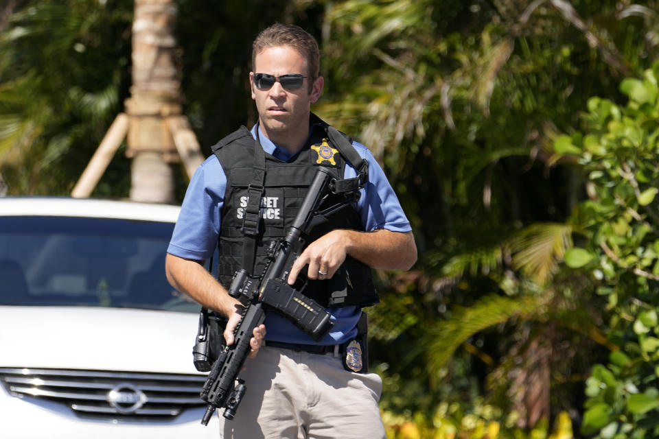 A Secret Service agent stands at an entrance to former President Donald Trump's Mar-a-Lago estate, Thursday, March 23, 2023, in Palm Beach, Fla. (AP Photo/Lynne Sladky)