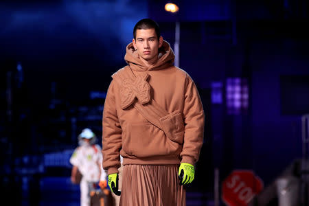 A model presents a creation by designer Virgil Abloh during a preview show for his Fall/Winter 2019-2020 collection for fashion house Louis Vuitton during Men's Fashion Week in Paris, France, January 17, 2019. REUTERS/Gonzalo Fuentes