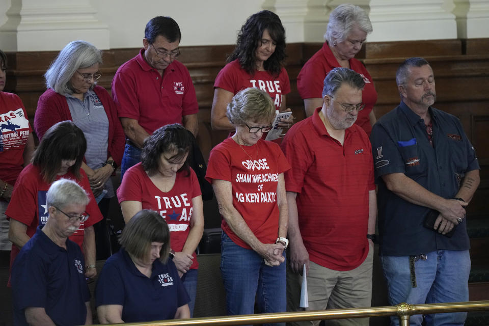 Supporters of Texas Attorney General Ken Paxton stand during a prayer during the impeachment trial for Paxton in the Senate Chamber at the Texas Capitol, Tuesday, Sept. 5, 2023, in Austin, Texas. (AP Photo/Eric Gay)