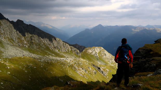 A hiker looks at a mountain range at the Hohe Tauern National Park near the village of Virgen, Austria, July 23, 2018. Picture taken July 23, 2018.