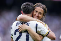 Real Madrid's Brahim Diaz, right, celebrates with his teammate Real Madrid's Luka Modric after scoring his side's opening goal during the the Spanish La Liga soccer match between Real Madrid and Cadiz at the Santiago Bernabeu stadium in Madrid, Spain, Saturday, May 4, 2024. (AP Photo/Manu Fernandez)