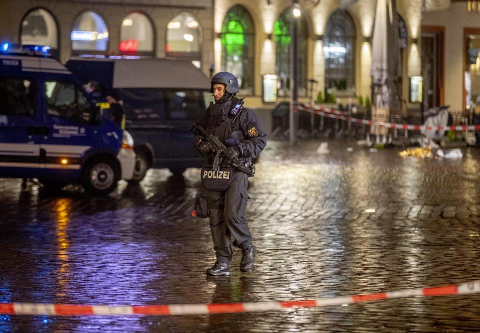 A police officer guards evidence at the scene of an incident in Trier, Germany, Tuesday, Dec. 1, 2020. German police say people have been killed and several others injured in the southwestern German city of Trier when a car drove into a pedestrian zone. Trier police tweeted that the driver had been arrested and the vehicle impounded.(AP Photo/Michael Probst)