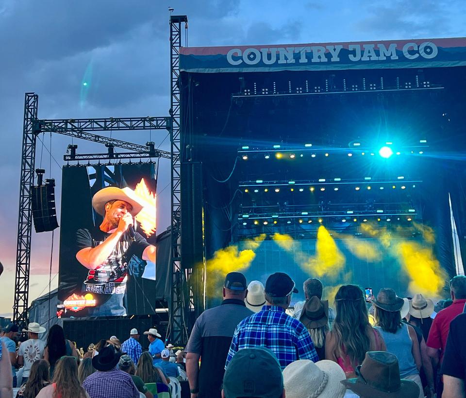 country jam co stage with blue and yellow lights and smoke