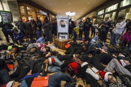 Protesters, demanding justice for the killing of 18-year-old Michael Brown, interrupt Black Friday shopping by staging a lie-in at the St. Louis Galleria Mall in Missouri November 28, 2014. REUTERS/Adrees Latif