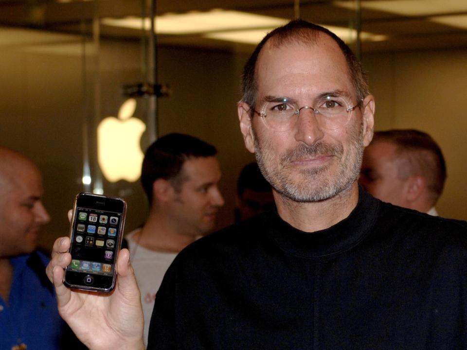 Steve Jobs holding the first generation iPhone in 2007.