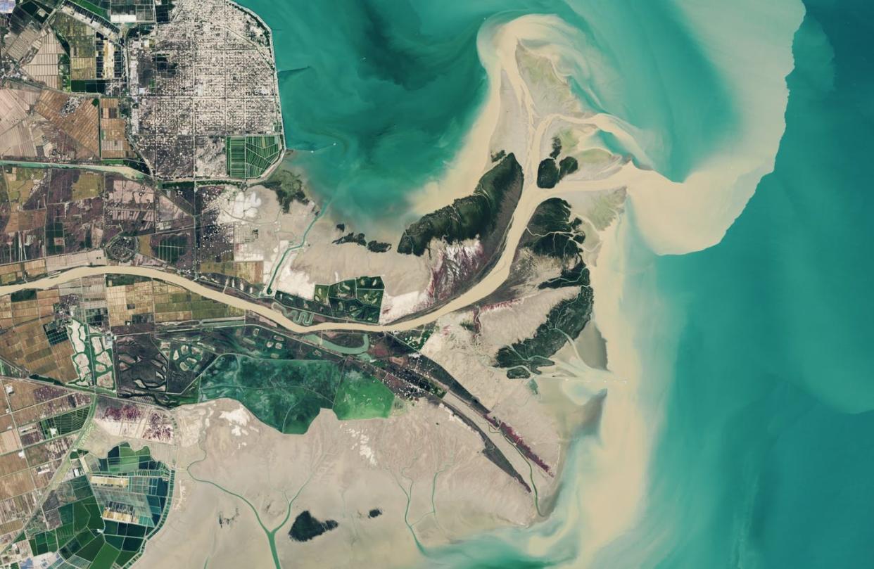 The Yellow River in China winds past aquaculture and an oil and gas field on its way to a newly formed channel. <a href="https://earthobservatory.nasa.gov/world-of-change/YellowRiver" rel="nofollow noopener" target="_blank" data-ylk="slk:NASA;elm:context_link;itc:0;sec:content-canvas" class="link ">NASA</a>