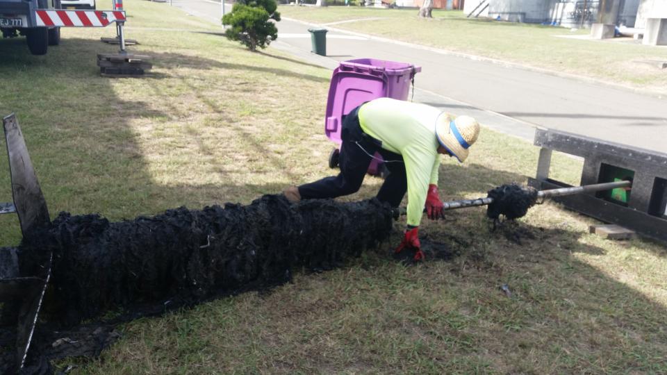 Sydney Water staff manually removing wet wipes from a blockage. (Image: Sydney Water)