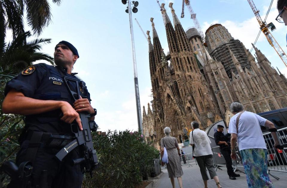 A police officer stands guard outside the Segrada Familia (AFP/Getty Images)