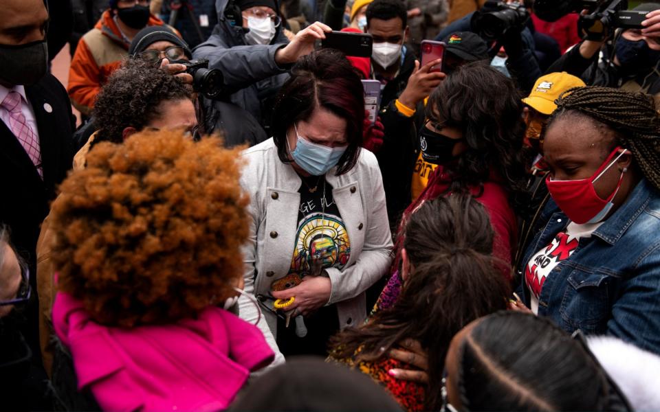 Courteney Ross (C), George Floyd's girlfriend, meets Katie Wright, the mother of Daunte Wright, who was killed by police in Minnesota last week - Stephen Maturen/Getty Images