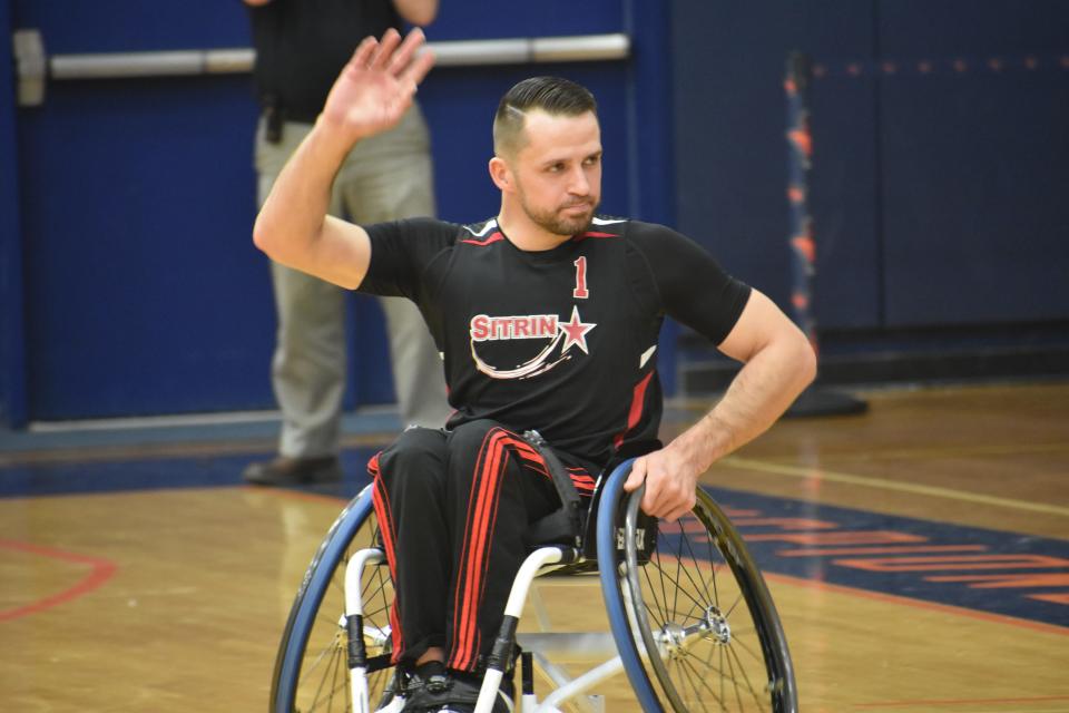 Utica's Hermin Garic (1) waves to the crowd during introductions at the 18th annual Sitrin Celebrity Wheelchair Classic at Utica University Thursday, April 28, 2022.