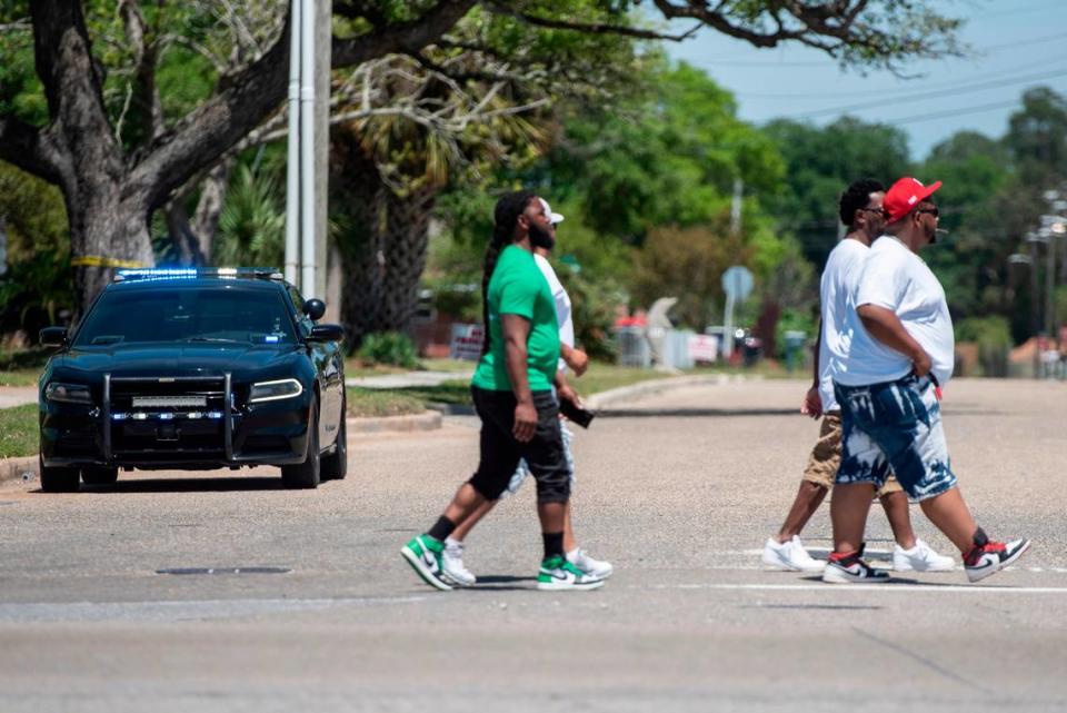 Spring breakers walk along Highway 90 in Biloxi during Black Spring Break on Saturday, April 13, 2024. Some attendees say they were bothered by the large police presence.