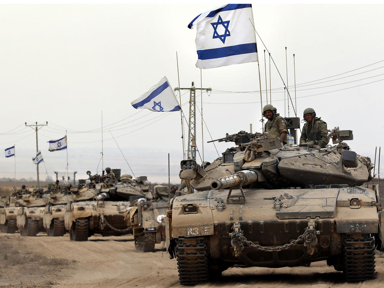 Israeli Merkava tanks drive near the border between Israel and the Gaza Strip as they return from the Hamas-controlled Palestinian coastal enclave on August 5, 2014,: AFP/Getty Images