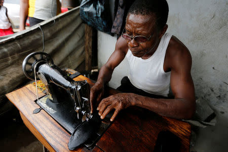 A man sews a shoe in Araria market in Aba, Nigeria August 19, 2016. REUTERS/Afolabi Sotunde