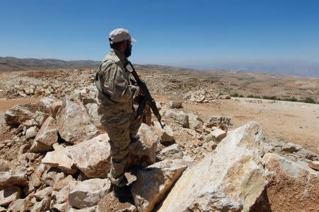 A Hezbollah fighter holds his weapon in Juroud Arsal, Syria-Lebanon border, July 25, 2017. REUTERS/Mohamed Azakir