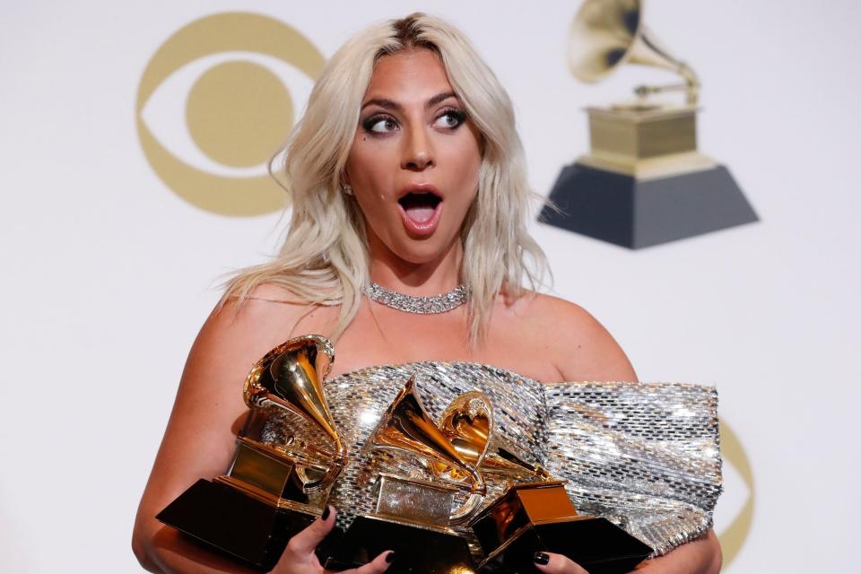 Lady Gaga poses backstage with her Grammy awards (Reuters)