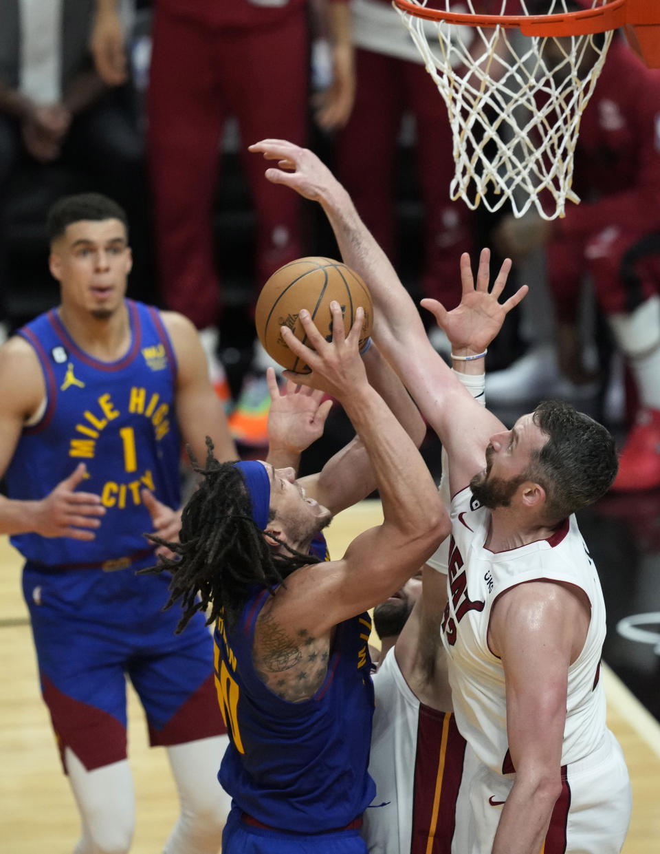 Denver Nuggets forward Aaron Gordon (50) drives to the basket as Miami Heat forward Kevin Love (42) during the second half of Game 3 of the NBA Finals basketball game, Wednesday, June 7, 2023, in Miami. (AP Photo/Rebecca Blackwell)