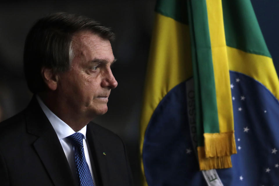 Brazil's President Jair Bolsonaro arrives to the Ministry of Justice to attend the inauguration of the new public defender, in Brasilia, Brazil, Tuesday, Jan. 19, 2021. (AP Photo/Eraldo Peres)