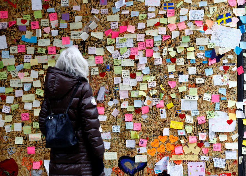 <p>A woman reads messages on a memorial wall near an area where a truck plunged into a crowd last month, at Ahlens department store along the pedestrian street of Drottninggatan in Stockholm, Sweden, May 8, 2017. (Ints Kalnins/Reuters) </p>