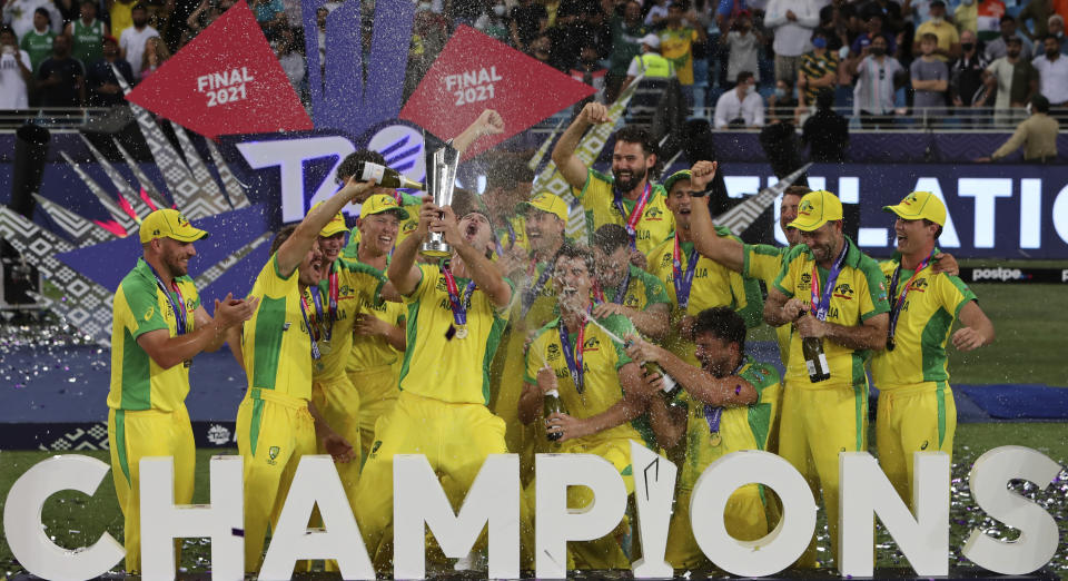 FILE - Australian cricketers celebrate after winning the Cricket Twenty20 World Cup final match in Dubai, UAE, Sunday, Nov. 14, 2021. The ninth T20 World Cup starts on June 1. The Caribbean and the United States are sharing co-host duties. (AP Photo/Aijaz Rahi, File)
