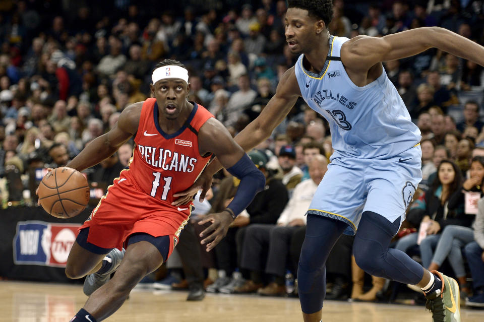 New Orleans Pelicans guard Jrue Holiday (11) drives against Memphis Grizzlies forward Jaren Jackson Jr. (13) in the first half of an NBA basketball game Monday, Jan. 20, 2020, in Memphis, Tenn. (AP Photo/Brandon Dill)